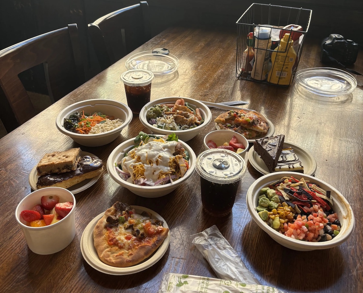 An assortment of food from the Teachers College Dining Hall on a wooden table.