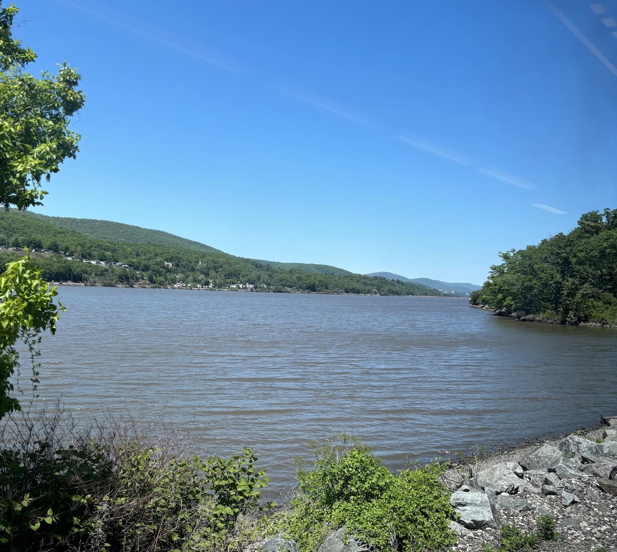 The Hudson River on a sunny day from a train.