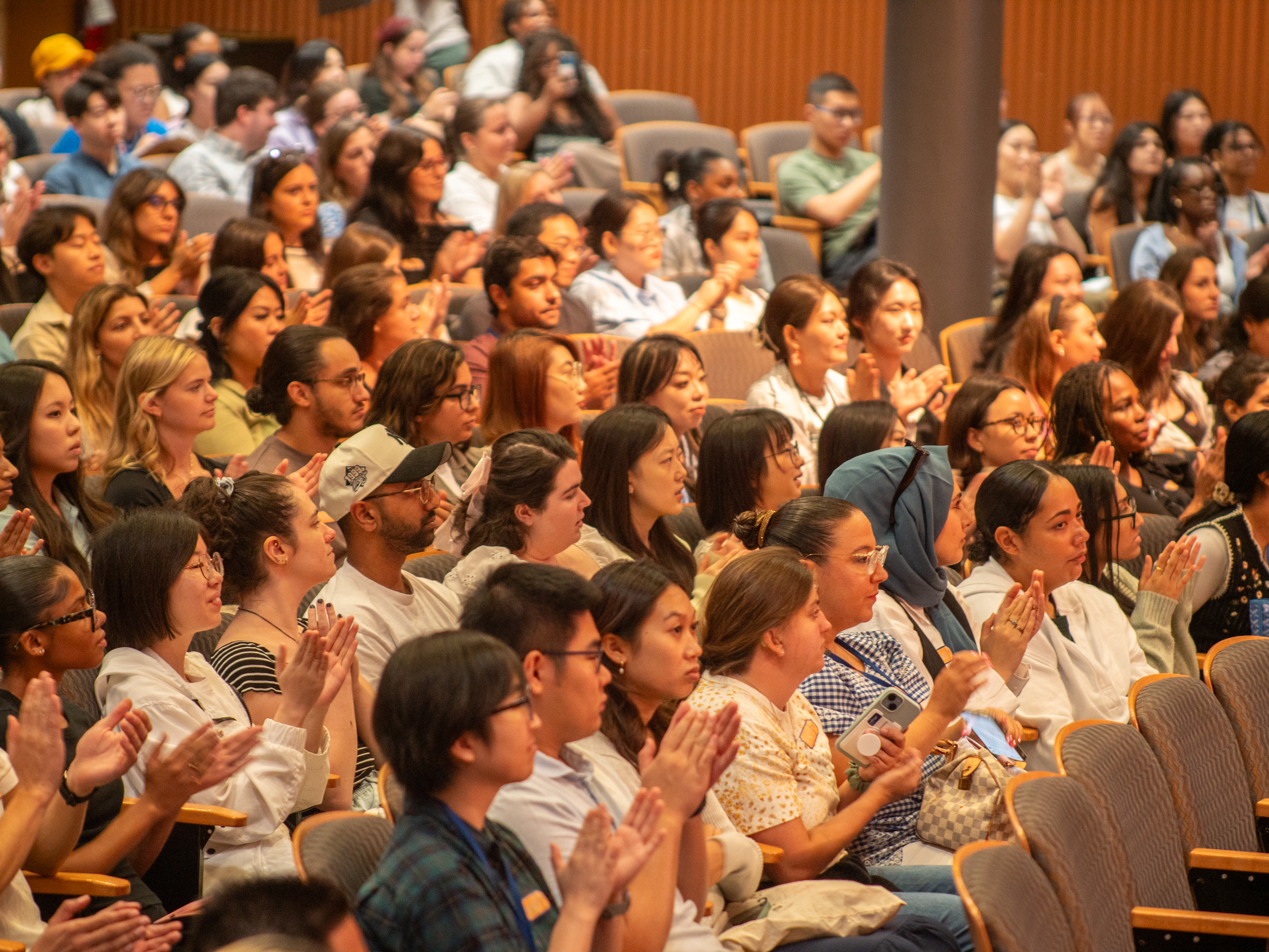 Students sitting in an auditorium for New student orientation