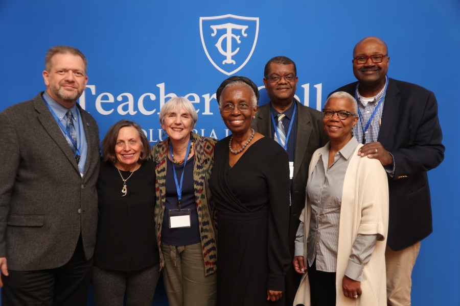 7 people standing and smiling at a TC Alumni Day 2024 event