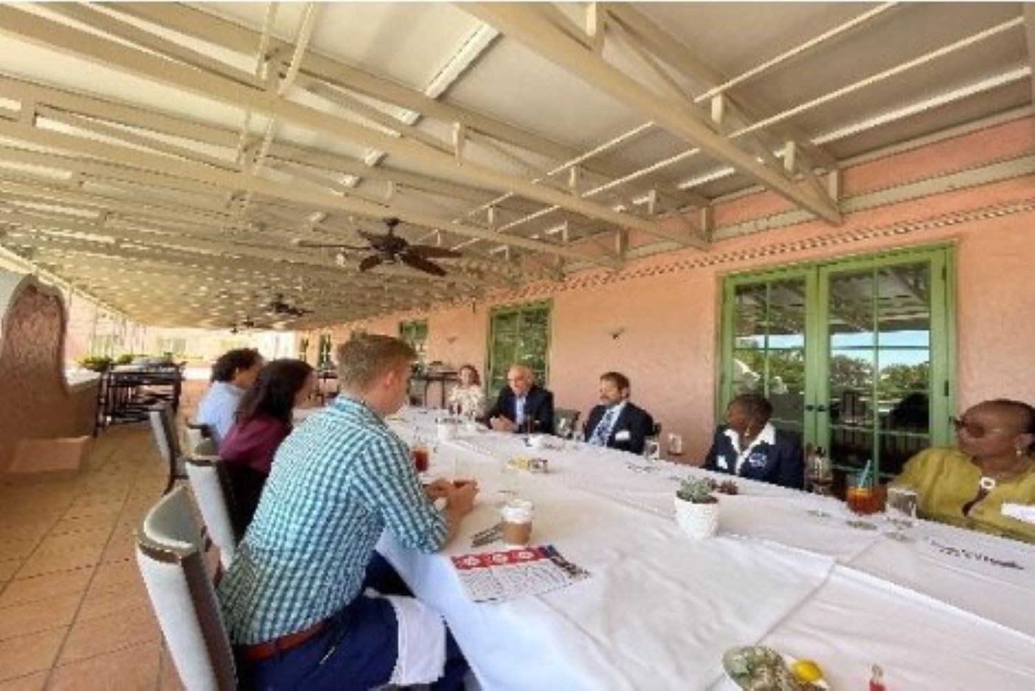 President Bailey and alumni seated at a long table facing one another