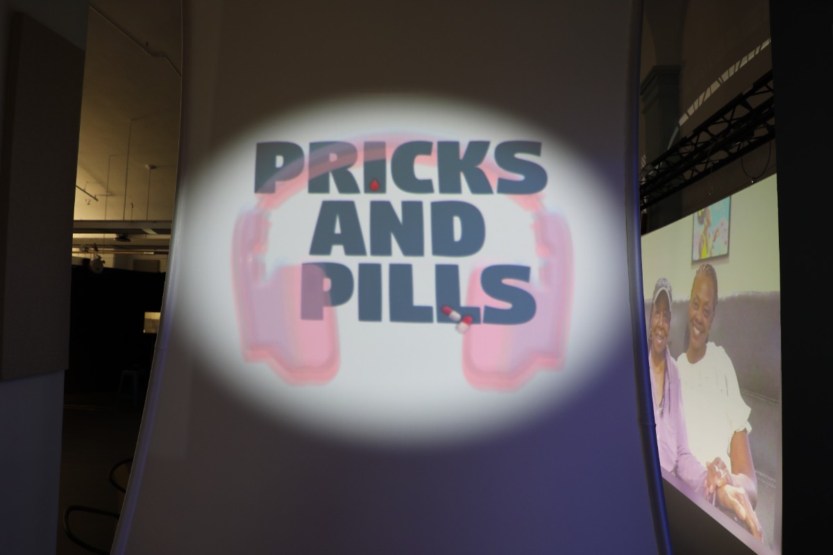 pricks and pills logo with headphones projected