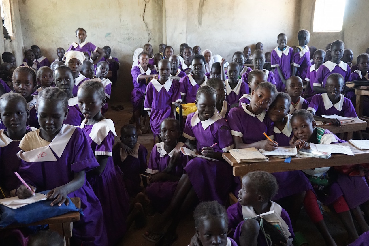Students in a classroom set-up at a refugee camp