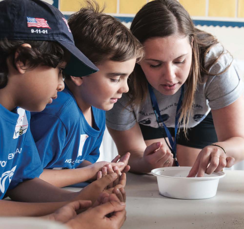 Teacher interacting with science campers