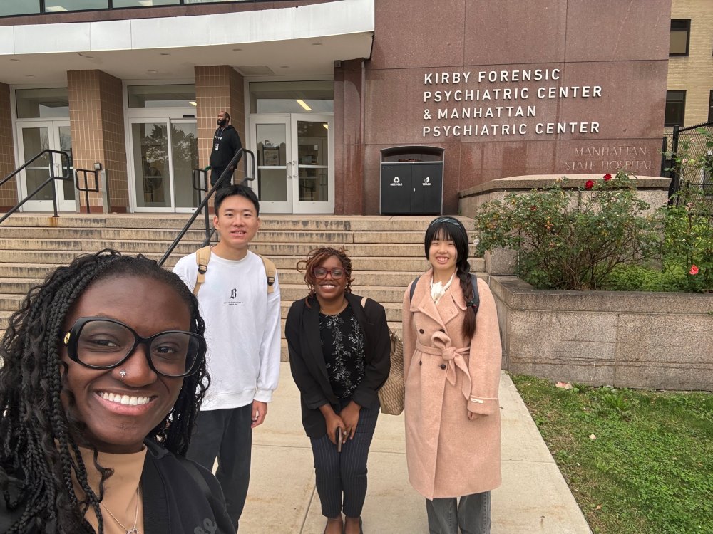 Four students standing in front of the Kirby Forensic Psychiatric Center and Manhattan Psychiatric Center