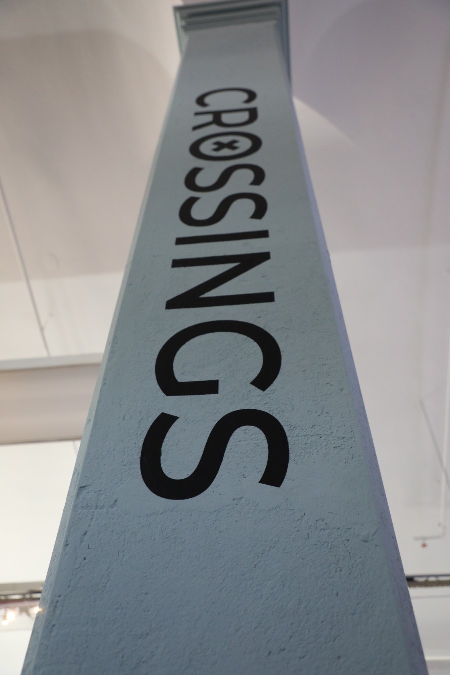 large lettering on column which read CROSSINGS