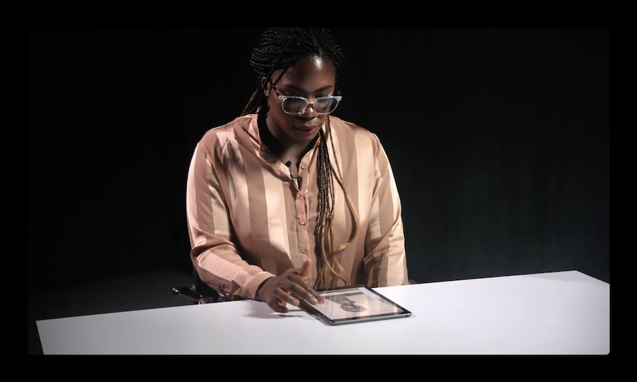Kadiatou Tubman contemplates primary source material on an iPad