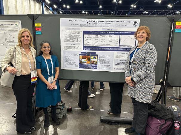 Standing in front of a poster