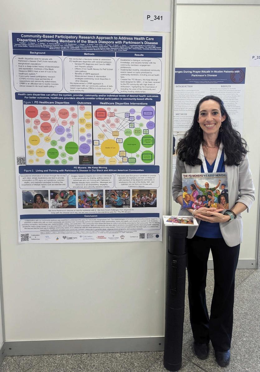 student standing beside a poster in a conference
