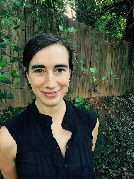 Jennifer Knox profile with woods and large brown fence background