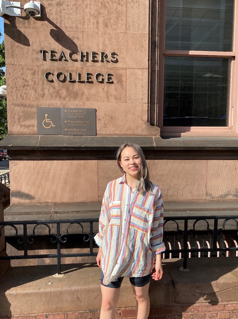 Melody Chuang posing for profile in front of TC building