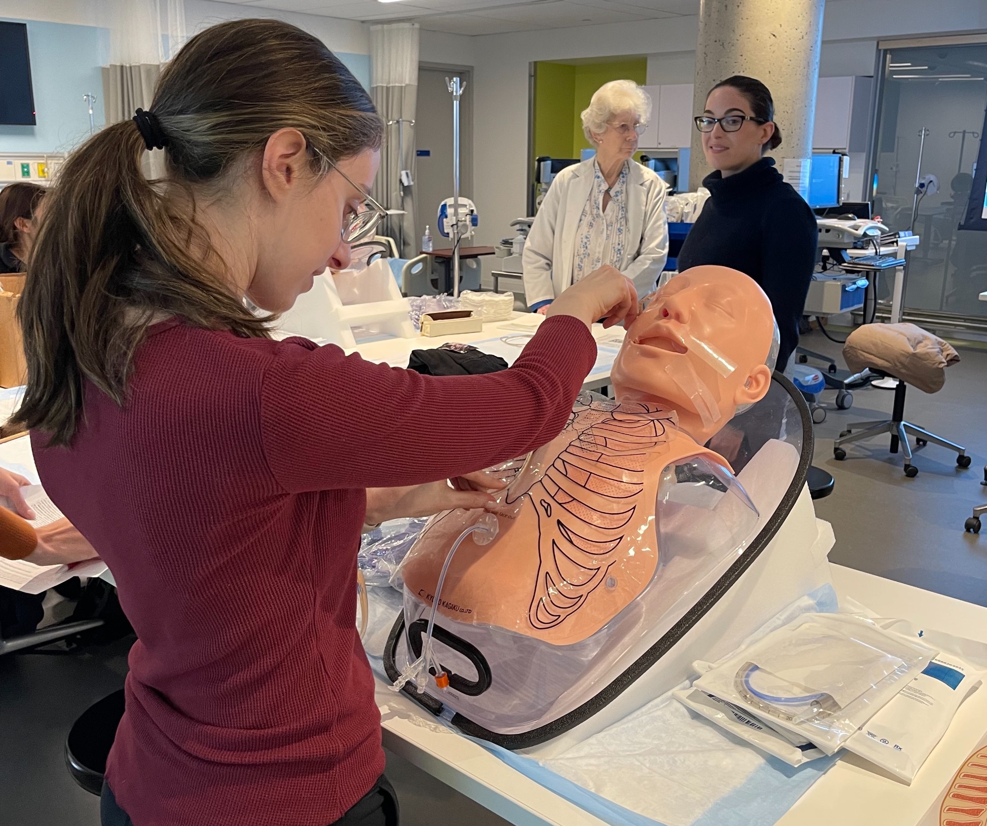 Female student practicing enteral tube placement in lab setting