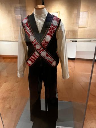 A suit from the Choctaw Nation of Oklahoma with two intricately beaded sashes is displayed on a mannequin