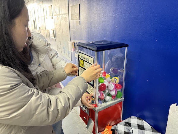 Image of the museum’s new capsule machine with prompts for visitors to answer