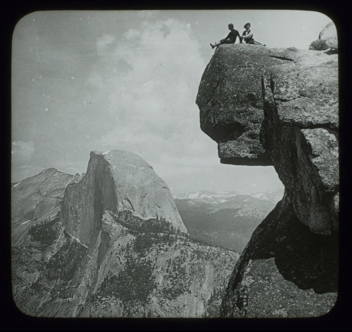 Lantern Slide of Two Figures on High on Top of a Rock, Looking towards Glacier Point in Yosemite National Park