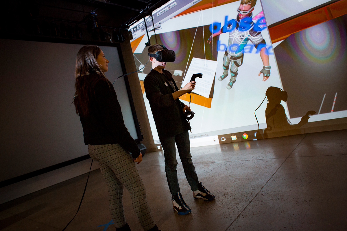 A student demos VR in front of a screen