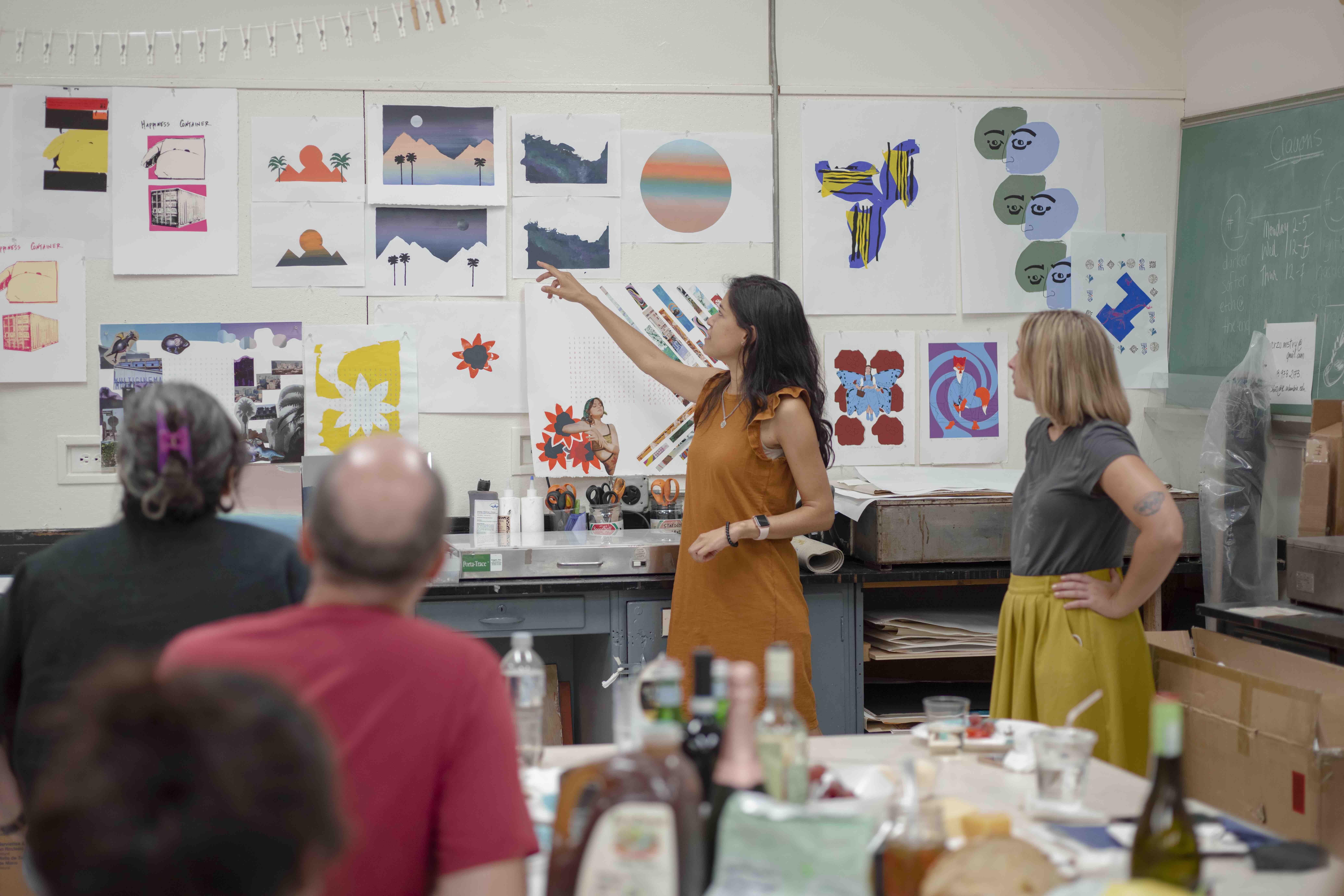 This is a picture of graduate students in the printmaking studio during a critique of their work.