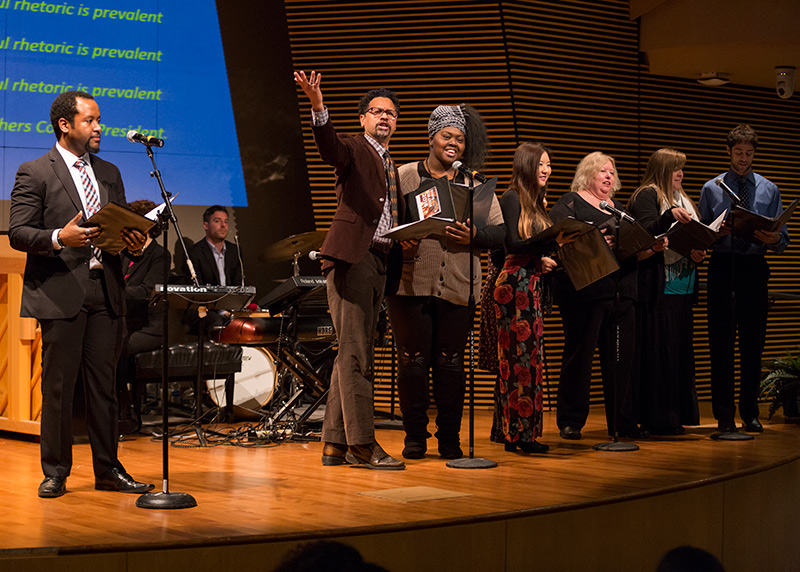 TC Student Senate President Drew Coles (left) and members of the TC Community Choir