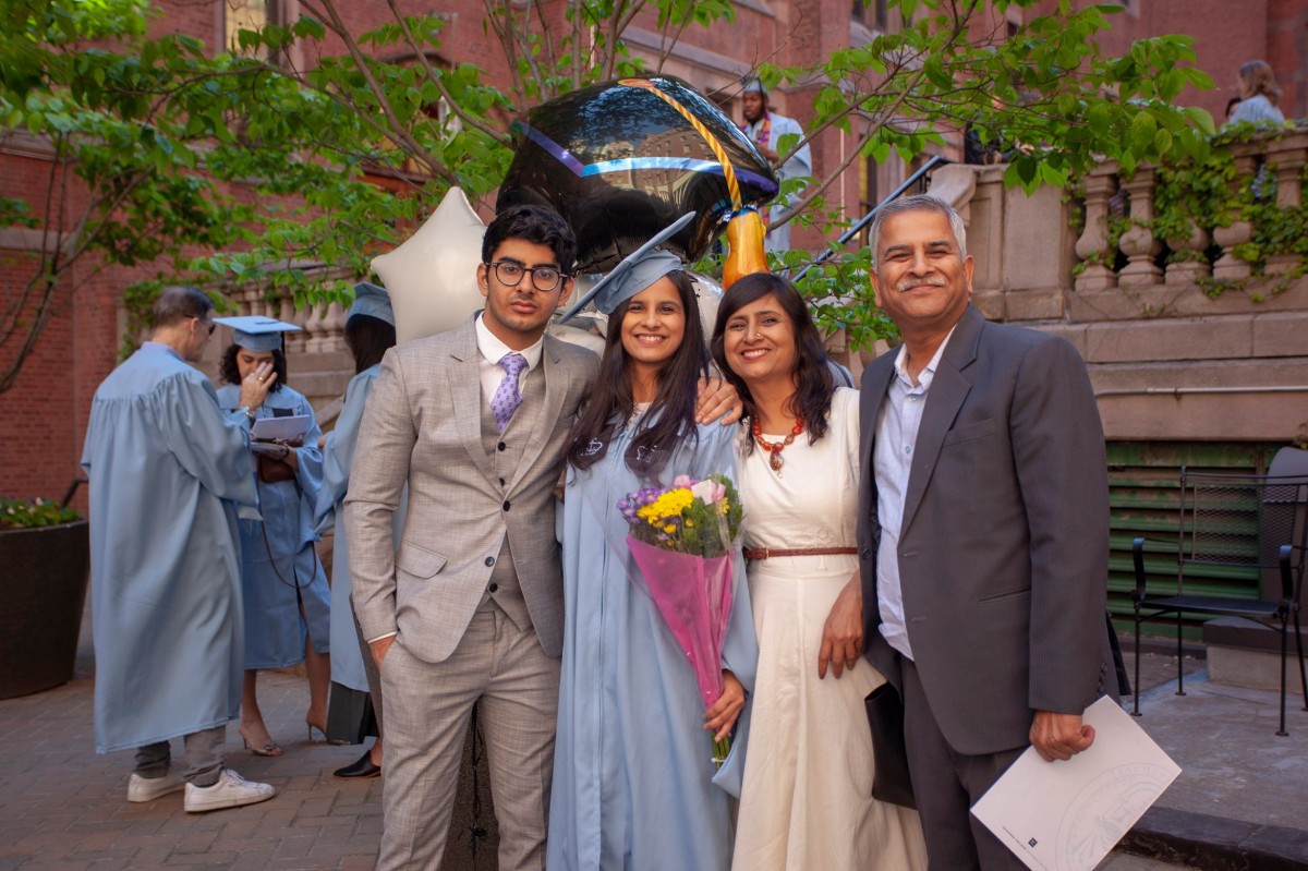 Graduates pose for a photo with parents after Convocation