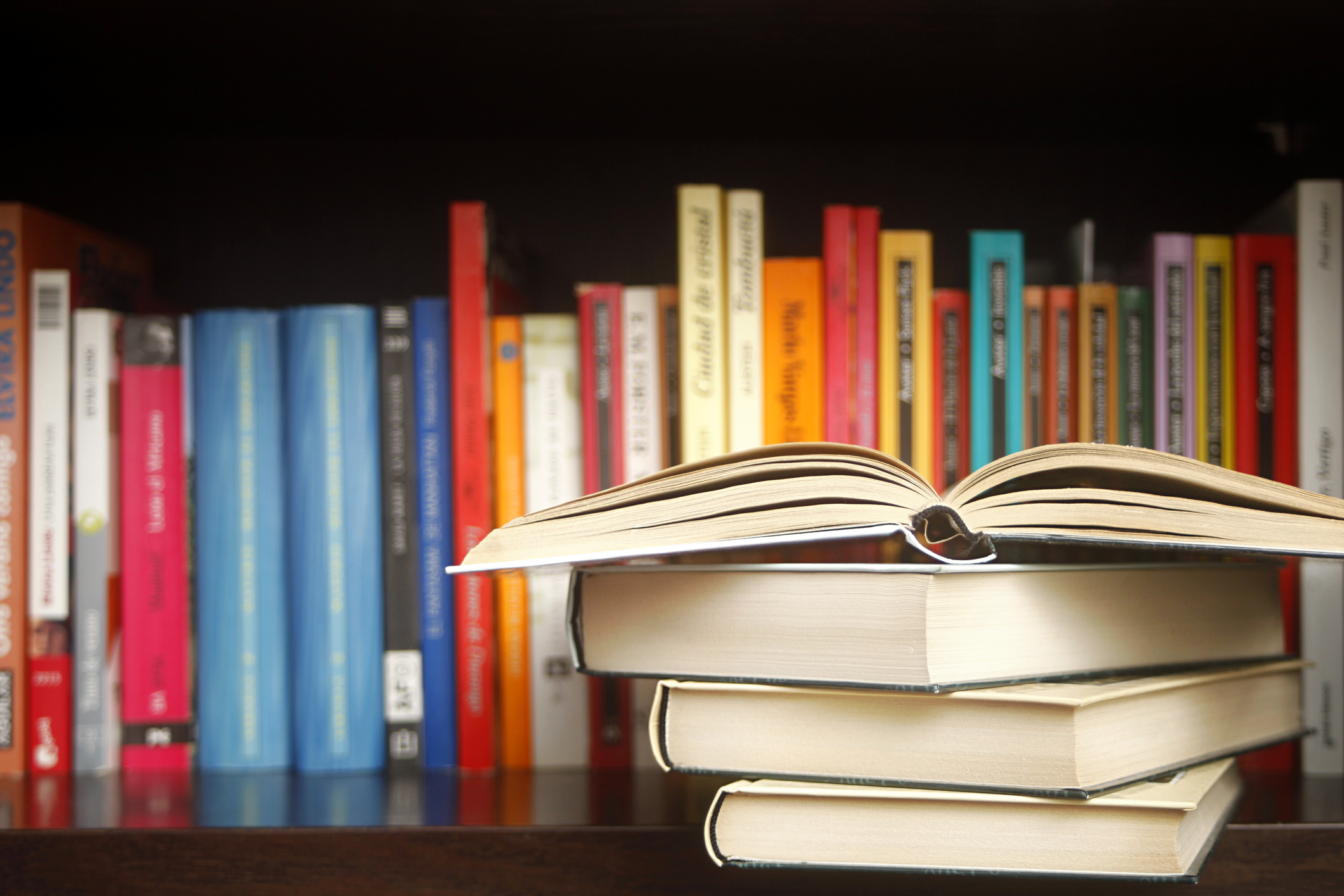 Colorful books on a shelf.