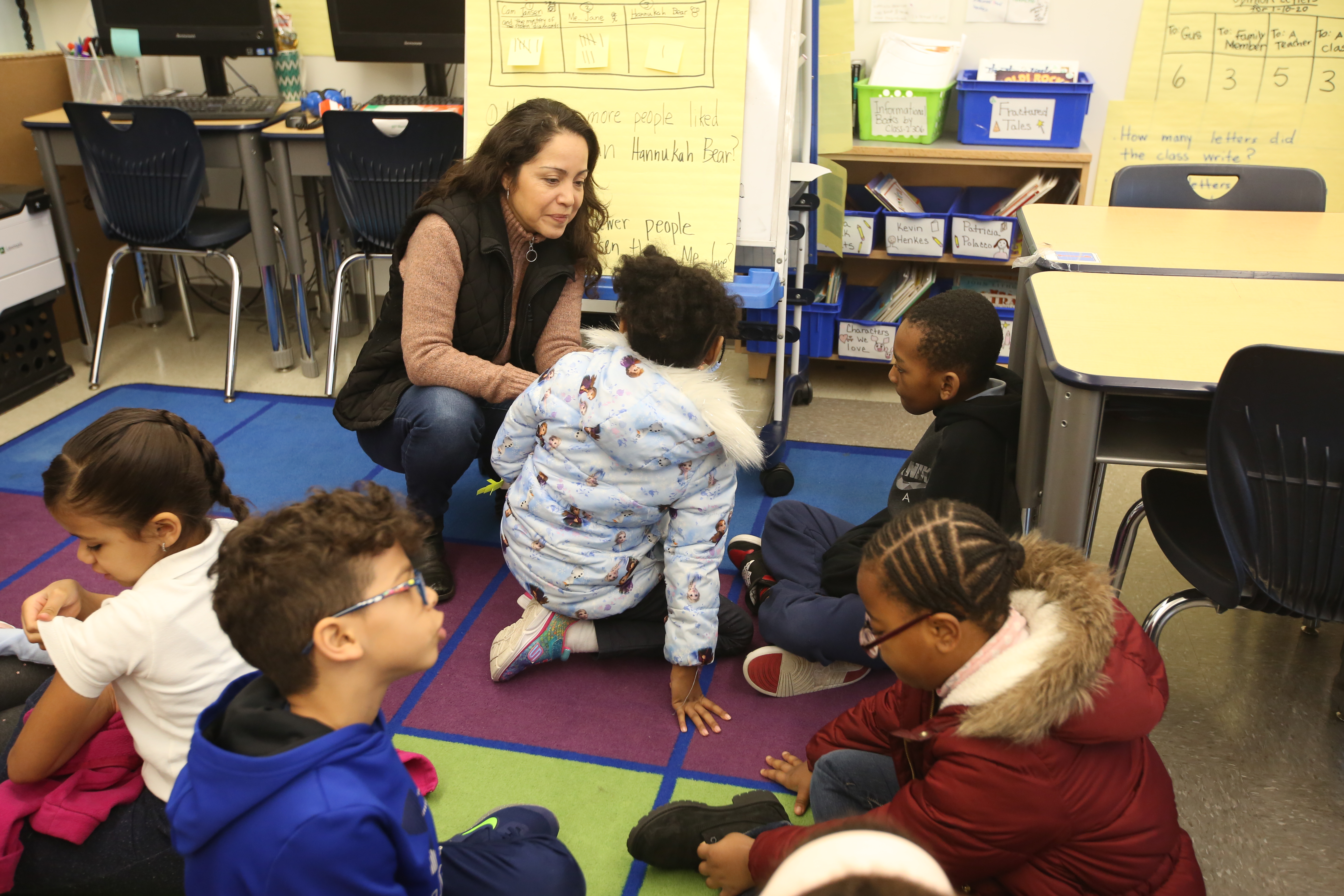 Students engaging with teacher in classroom.