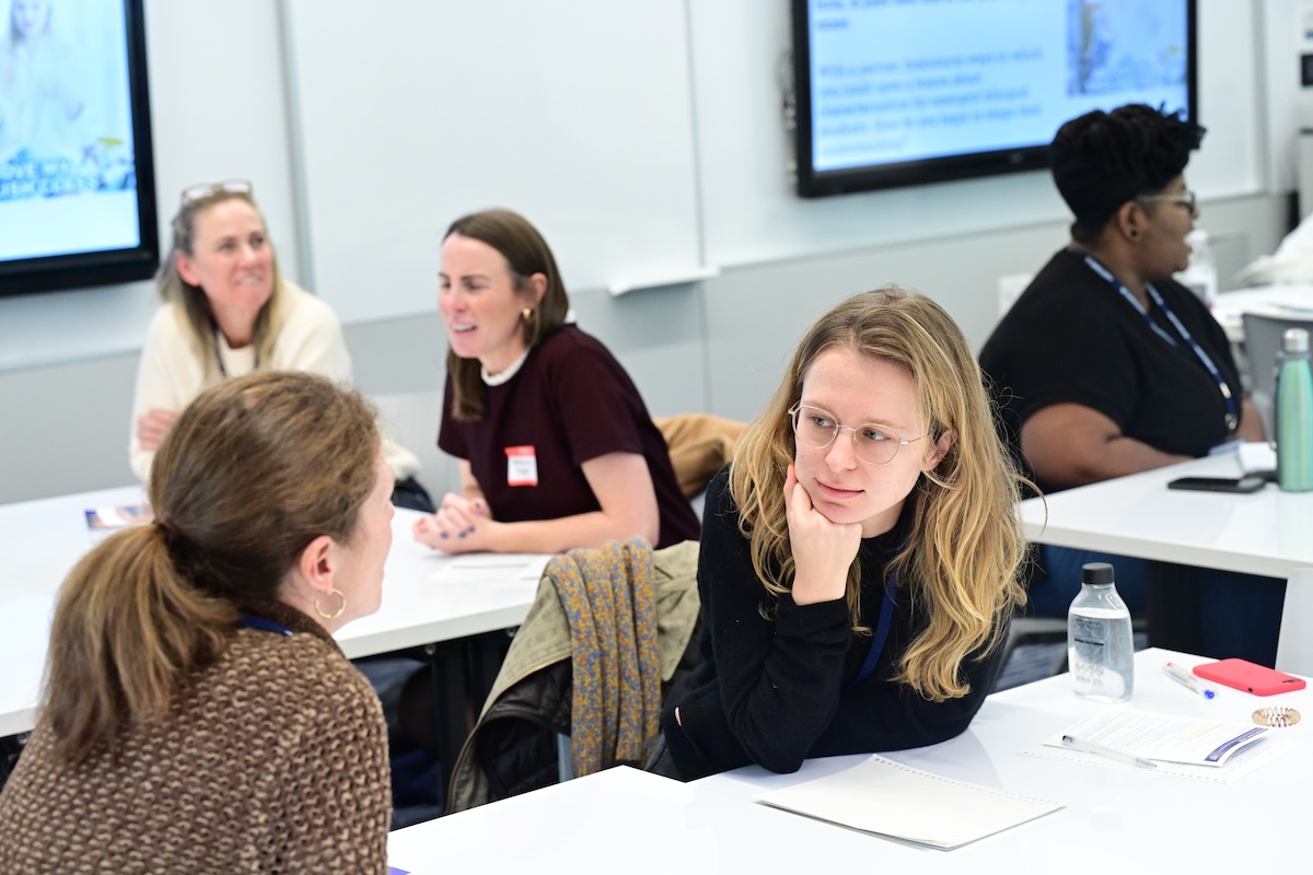 Two women in an engaging conversation at a conference