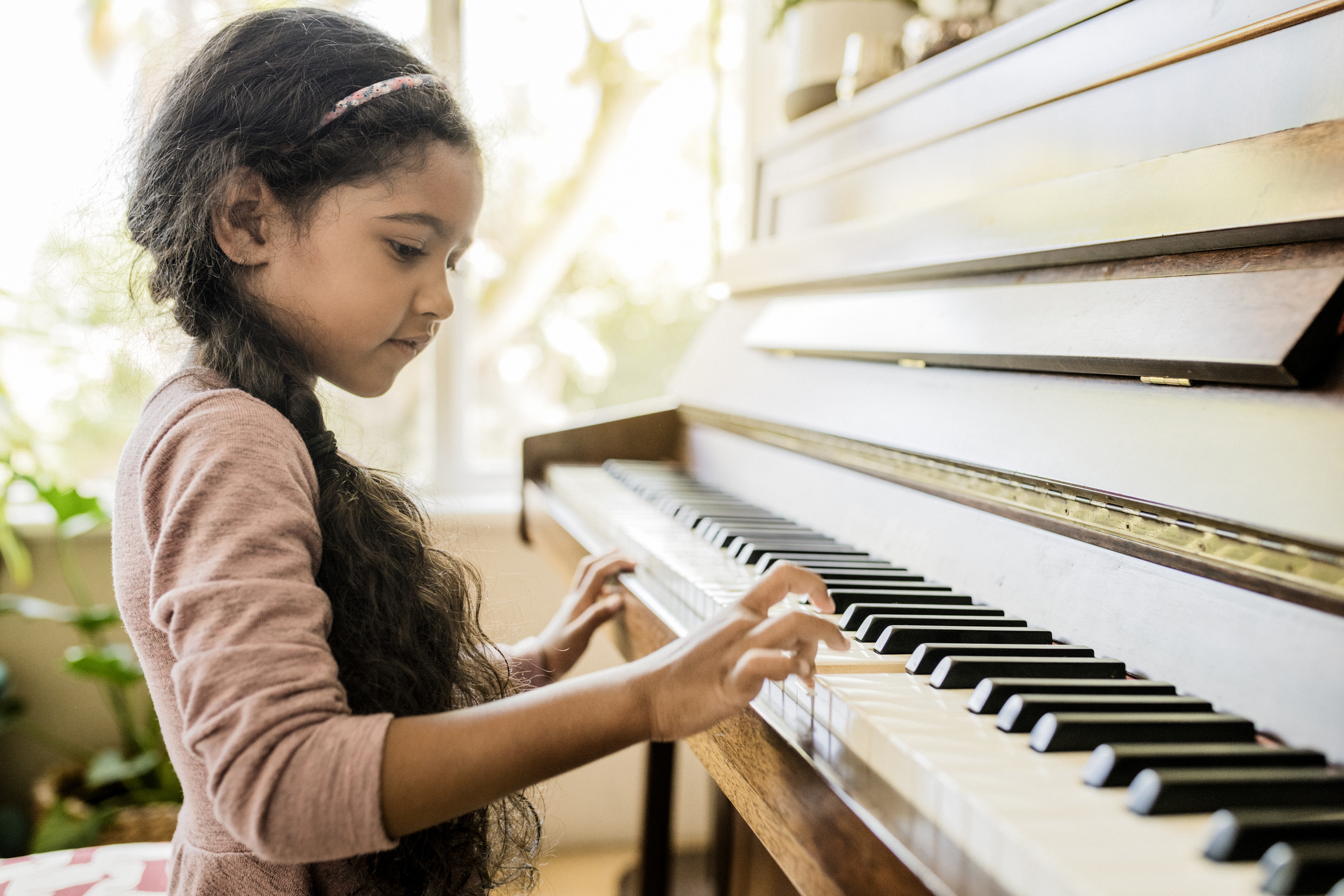 Young girl playing the piano.