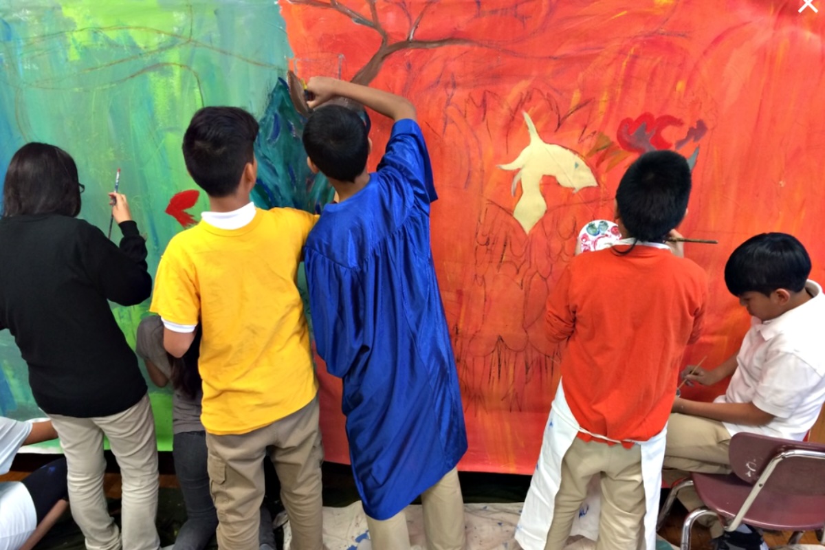 Boys painting mural