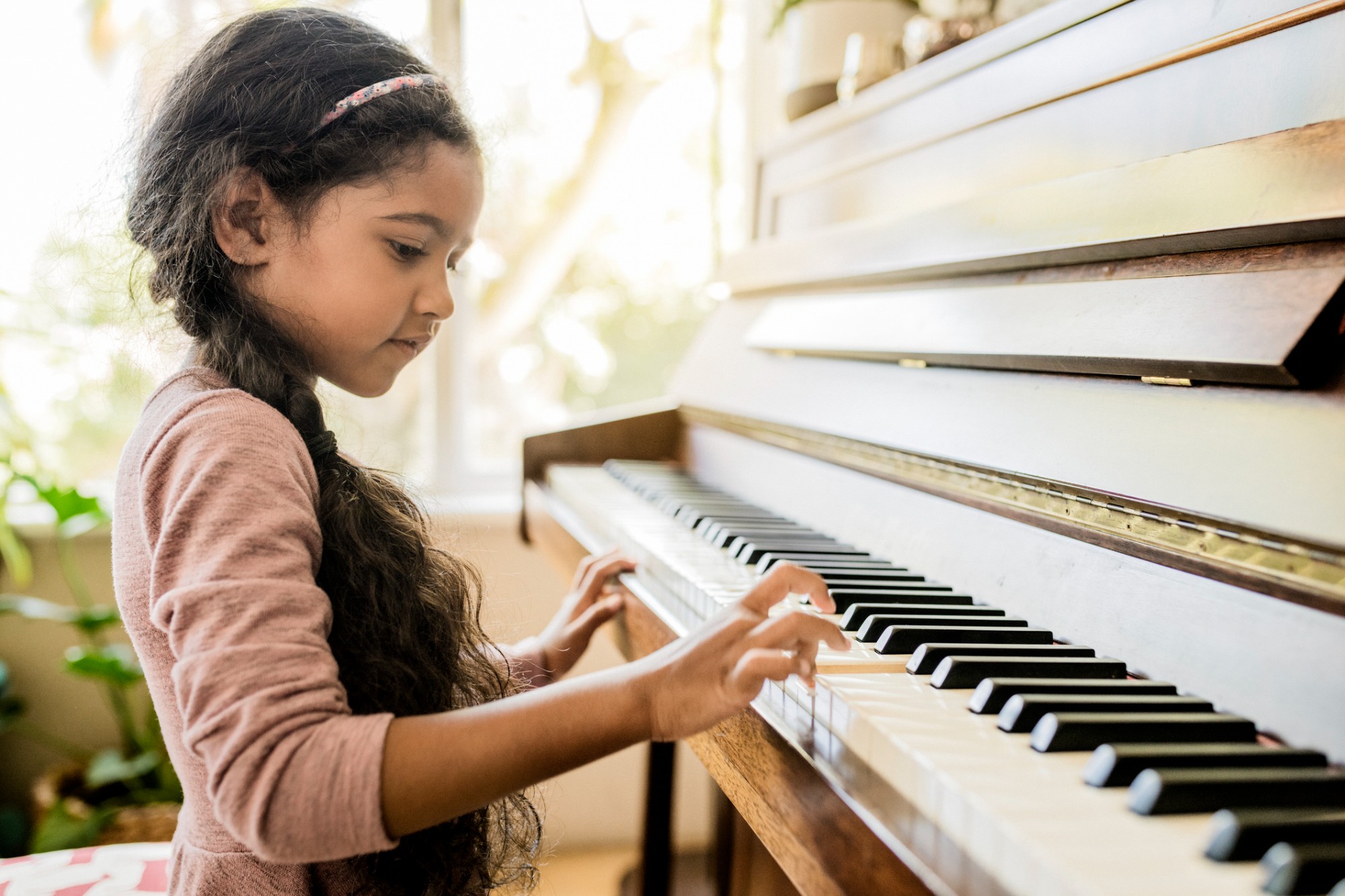 Young girl playing the piano.