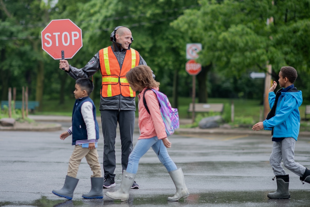 crossing guard with students at school