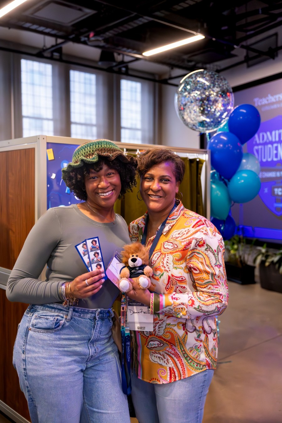 Students smiling at photo booth.