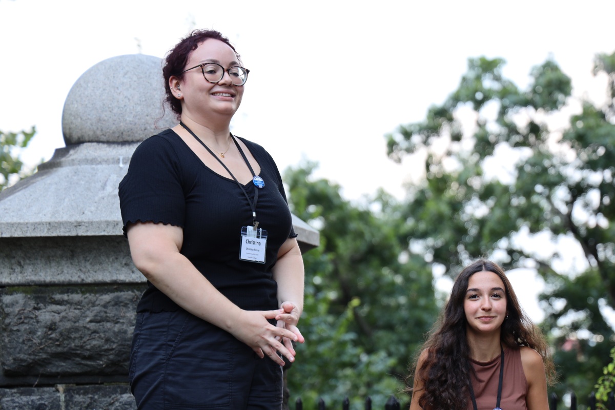 Christina Torres smiling and standing with her hands clasped in front of her