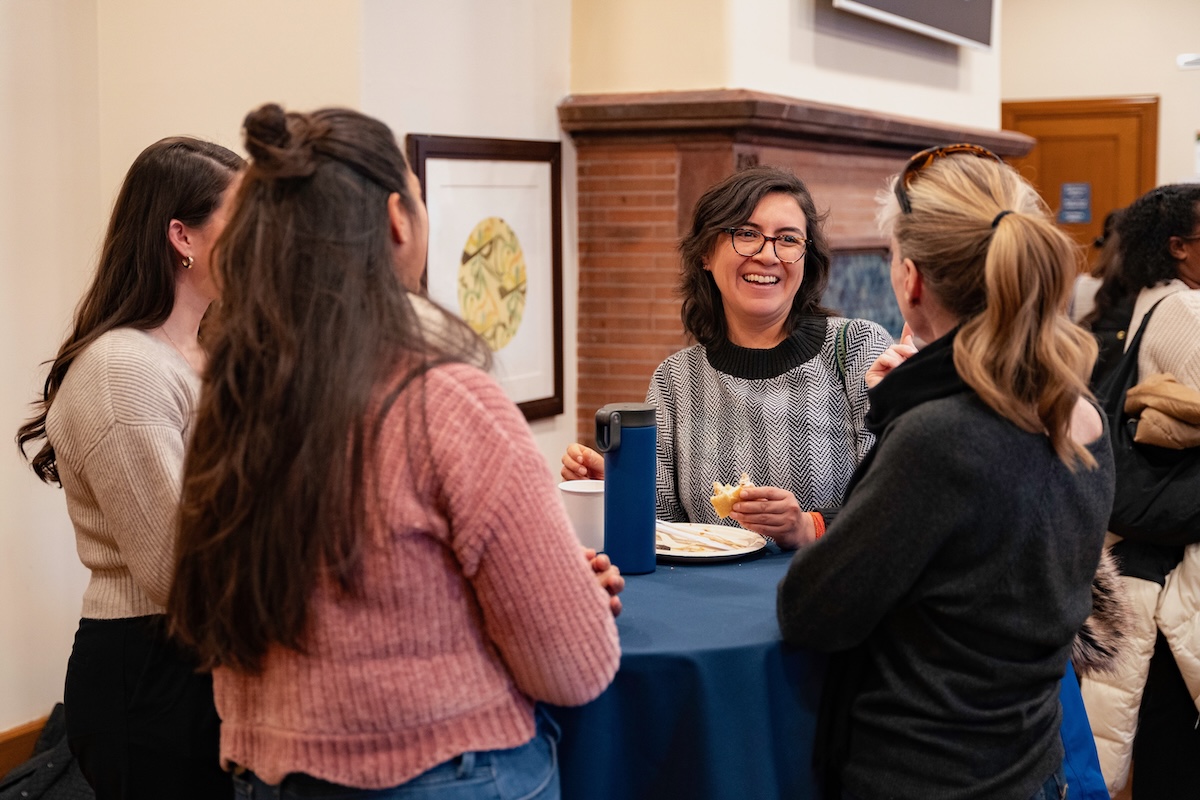 Four women having a conversation around a table