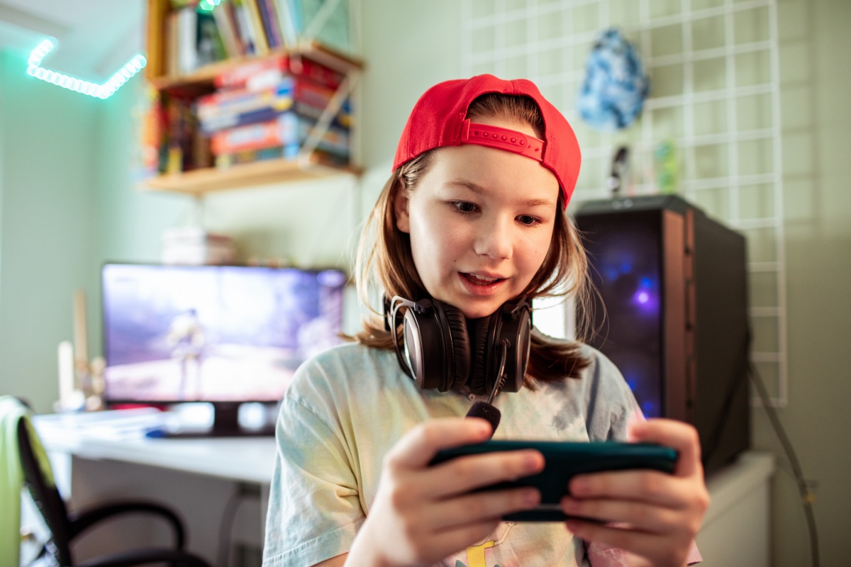 child with handheld video game inside