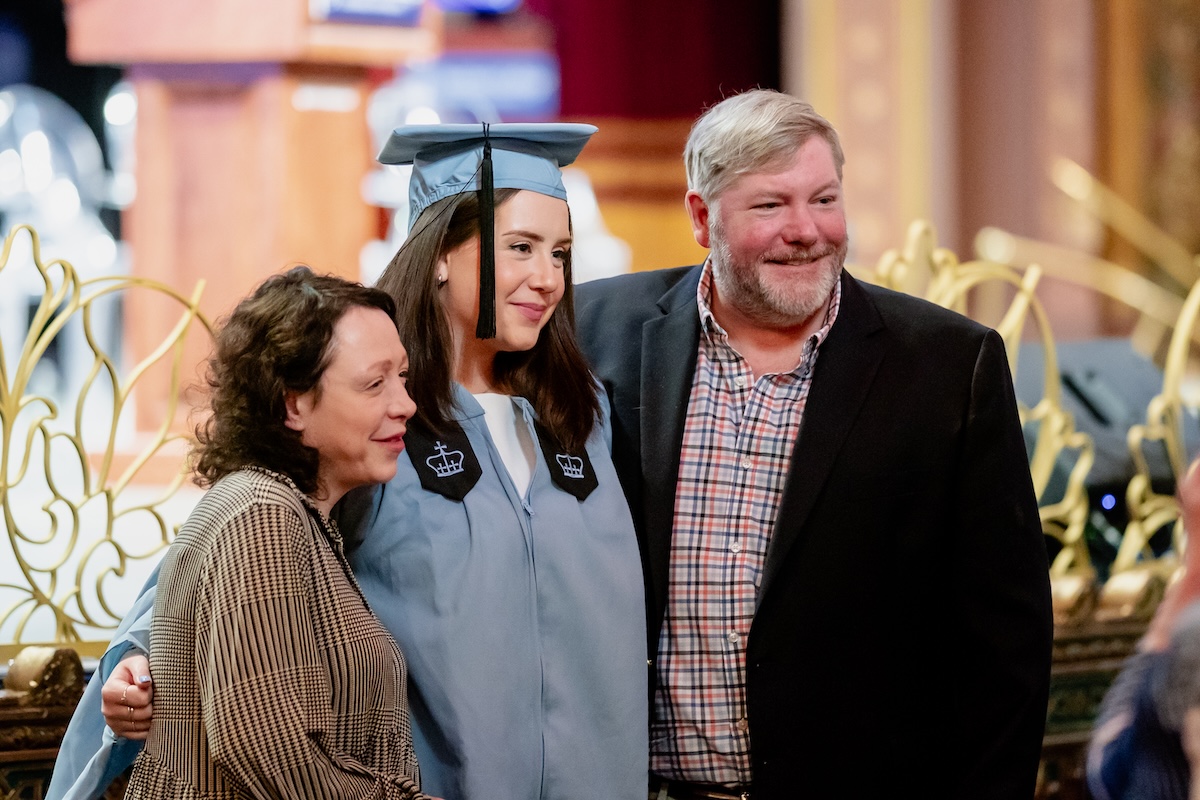 Family poses for group photo with graduate