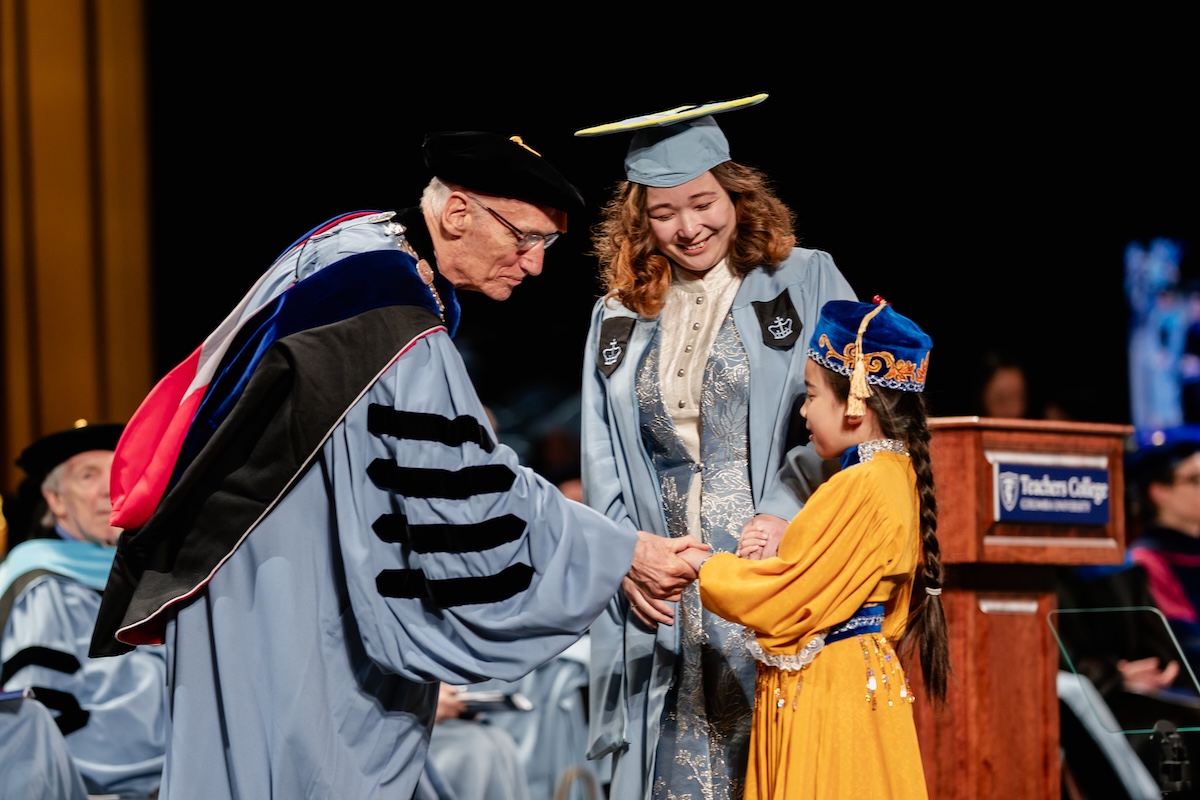 President Bailey with a child and her graduating mother