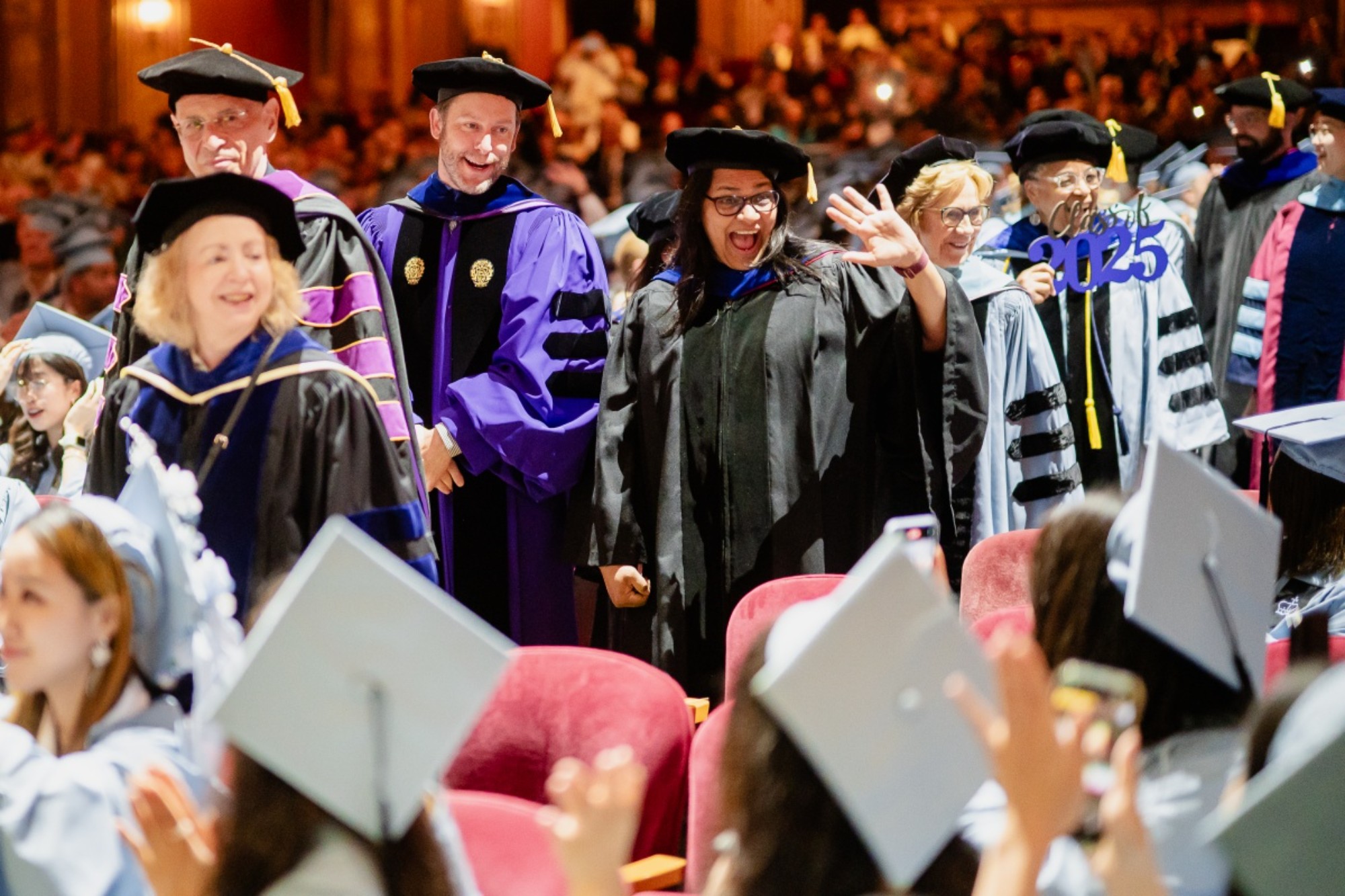 Lalitha Vasudevan and Nathan Holbert wave to students