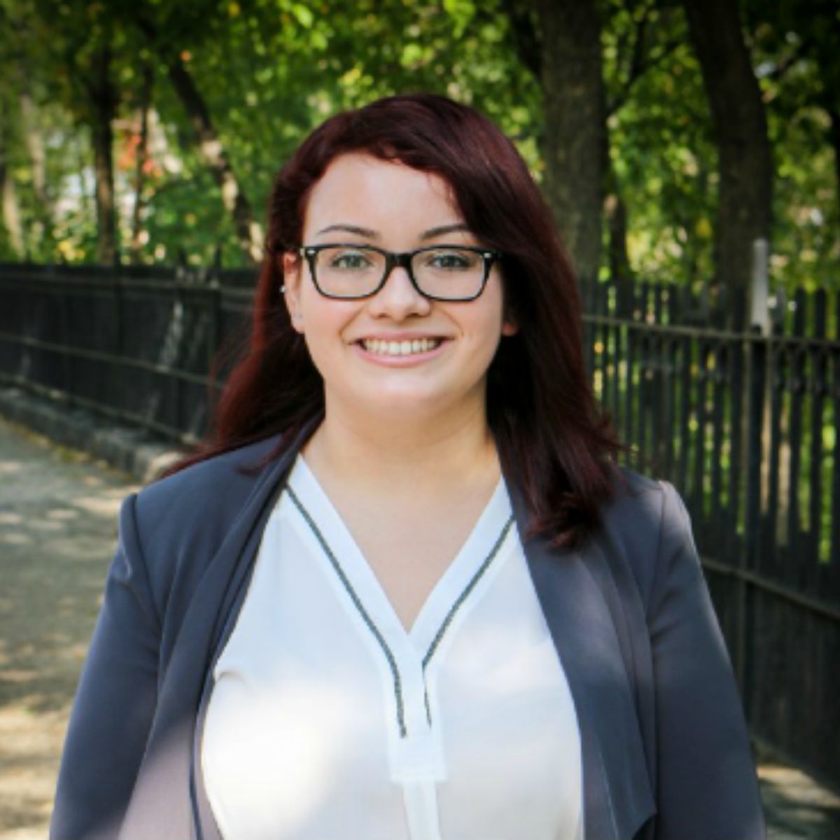 Christina Torres smiling and wearing glasses