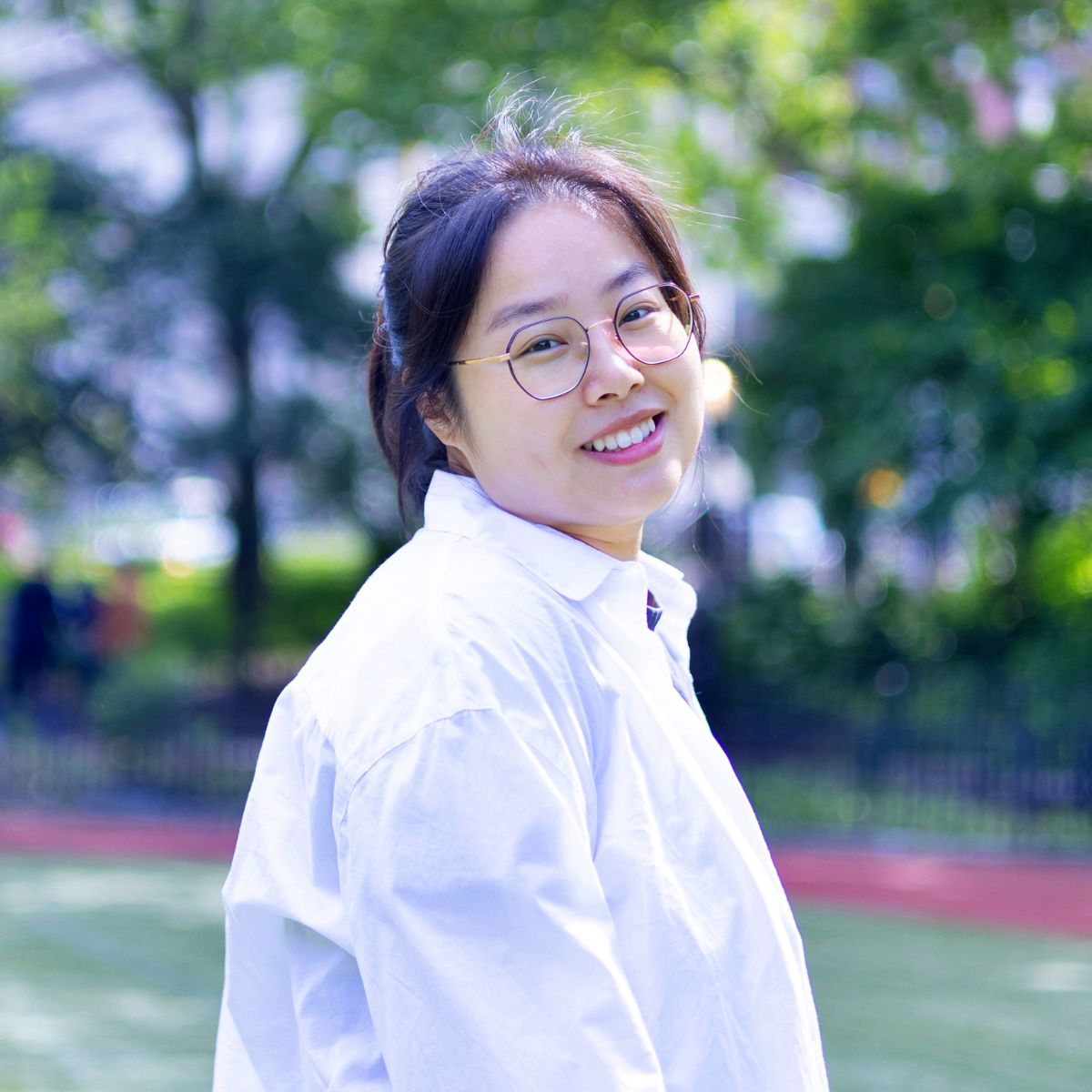 Susan Guo smiling in a park